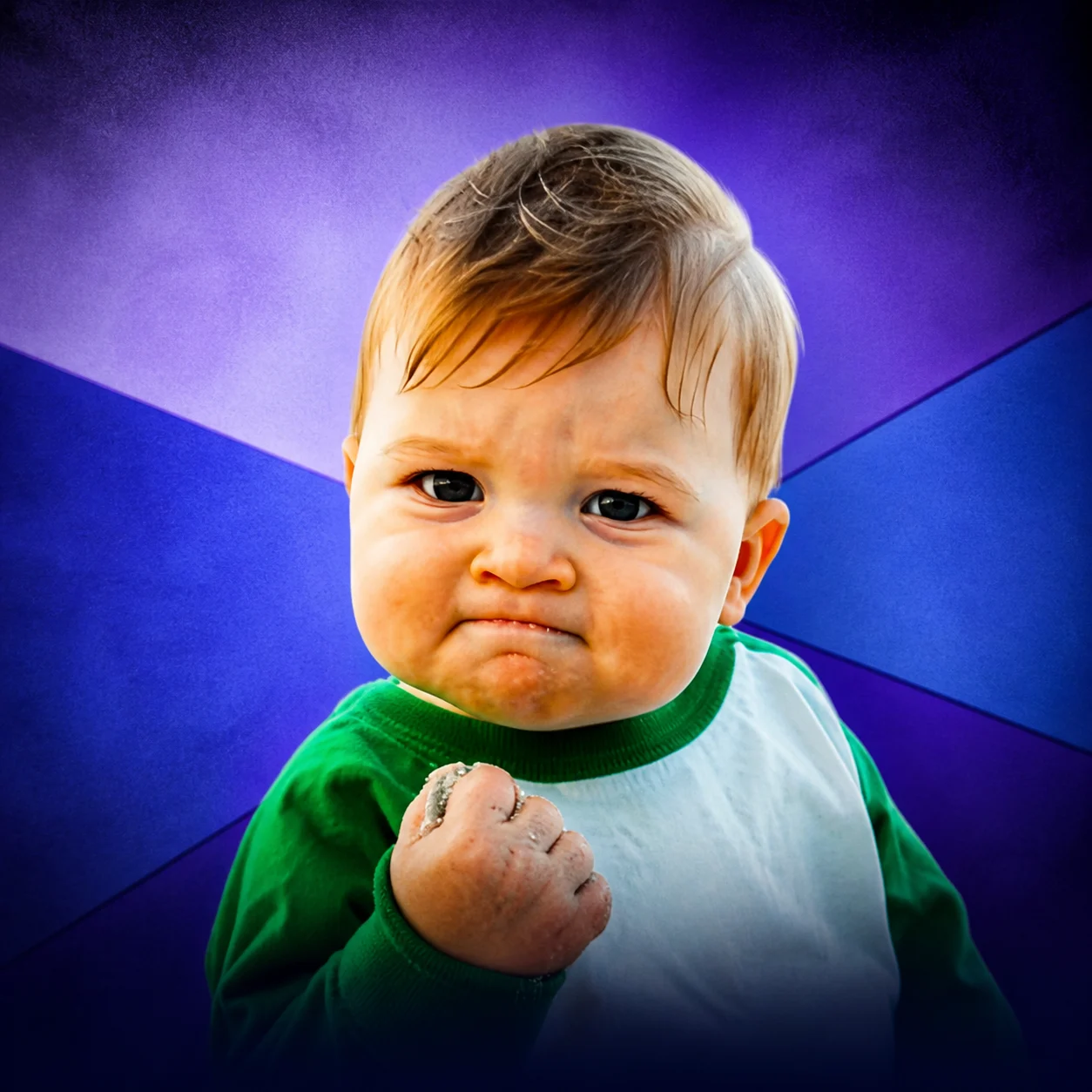 Determined toddler making a triumphant fist